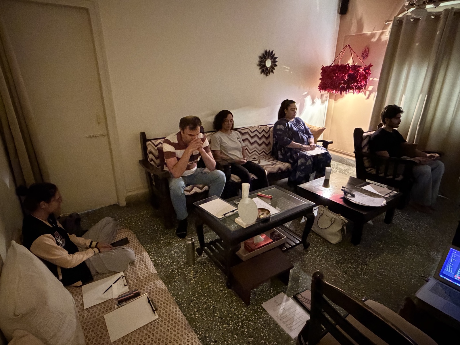 A quiet workshop room with participants practicing silence